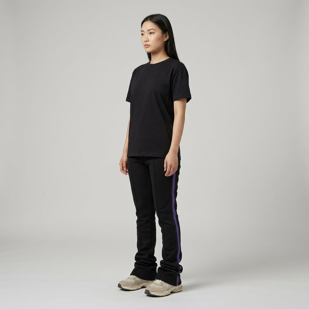 Urban Flare Joggers in black with purple side stripes, worn by a model standing against a neutral background.