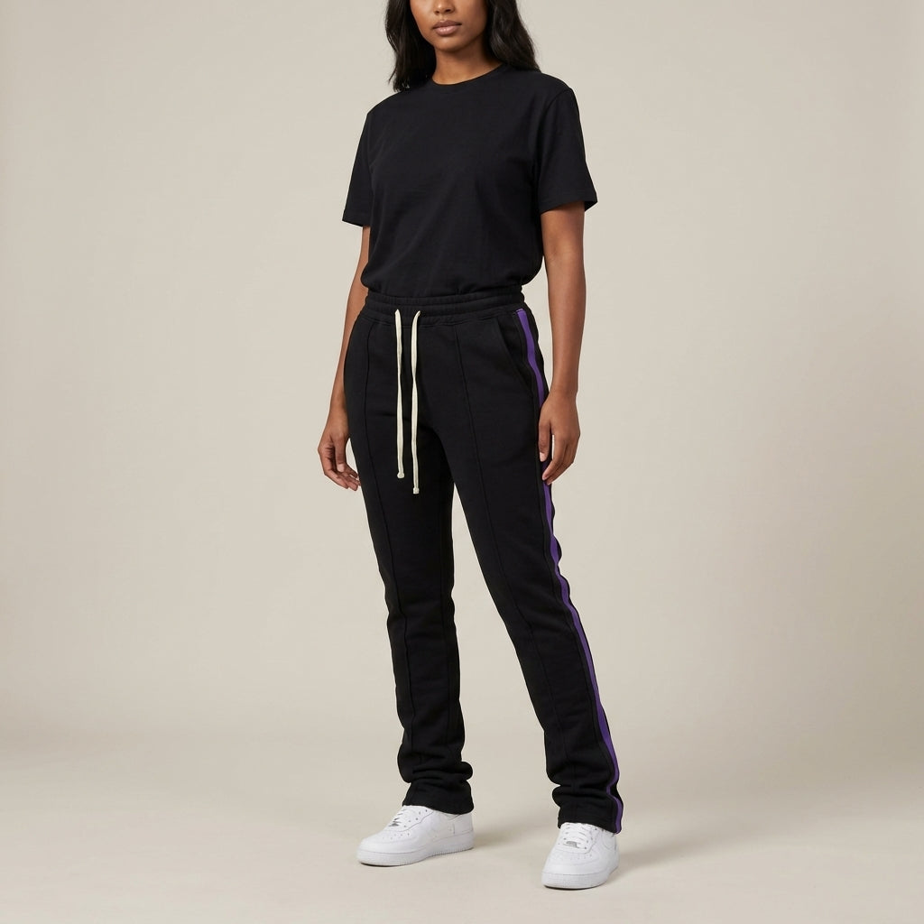 Urban Flare Joggers in black with purple side stripes, paired with a black t-shirt and white sneakers.