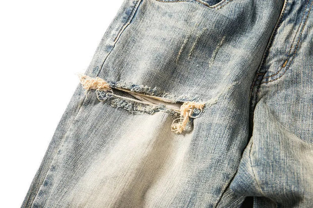 Shatter Fade Zippered Destroyed Jeans – Light Blue Ripped Streetwear Denim, Inner Zipper Detail, GOAT Streetwear Essentials