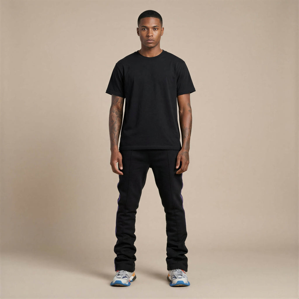 Urban Flare Joggers in black, worn by a model standing against a neutral background, paired with a black t-shirt and sneak...