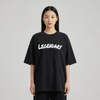 Black LEGENDARY T-shirt displayed on a model, featuring bold white lettering and a relaxed fit.