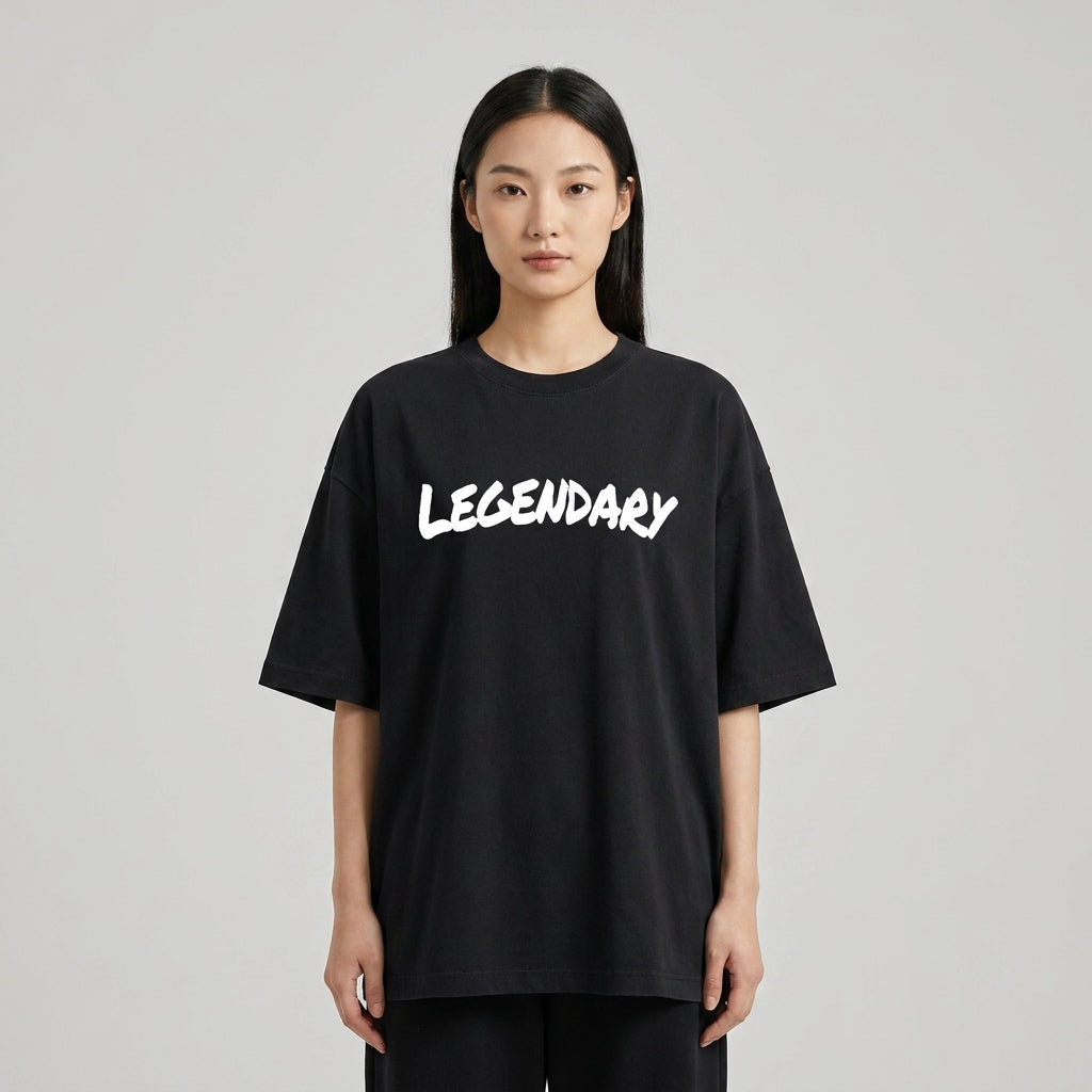 Black LEGENDARY T-shirt displayed on a model, featuring bold white lettering and a relaxed fit.