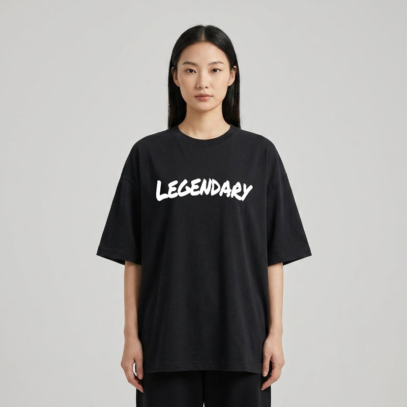 Black LEGENDARY T-shirt displayed on a model, featuring bold white lettering and a relaxed fit.