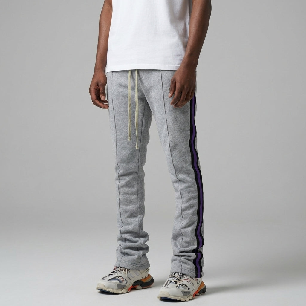 Urban Flare Joggers in light gray with purple side stripes, worn by a model standing against a neutral background.